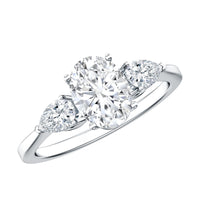 Oval and pear cut Moissanite three stone engagement ring from Rosec Jewels with sparkling gemstones and elegant setting.