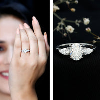 Oval and pear cut moissanite three-stone engagement ring by Rosec Jewels, featuring sparkling stones set in elegant ring band.