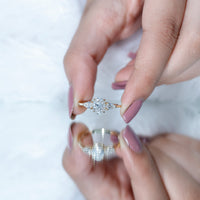Oval and pear cut moissanite three-stone engagement ring with rose gold band from Rosec Jewels, close-up view of the elegant ring design.