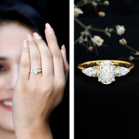 Oval and pear cut moissanite three-stone engagement ring from Rosec Jewels featuring a sleek silver band and sparkling gemstones.