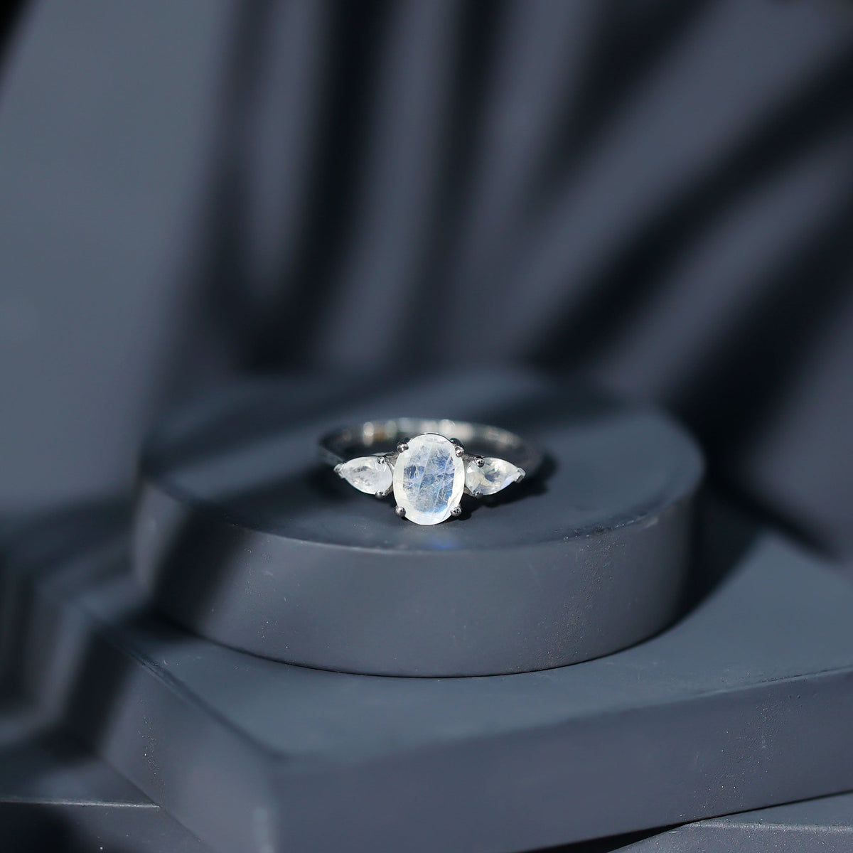 Natural moonstone three-stone engagement ring by Rosec Jewels featuring elegant, polished gemstones and a delicate band design.