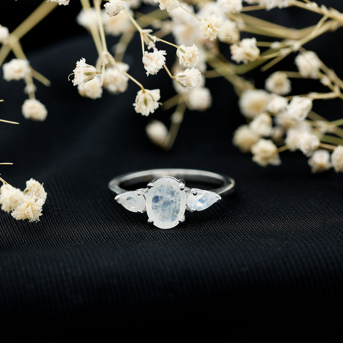 Natural moonstone three-stone engagement ring by Rosec Jewels featuring a delicate band and sparkling moonstone gemstones.