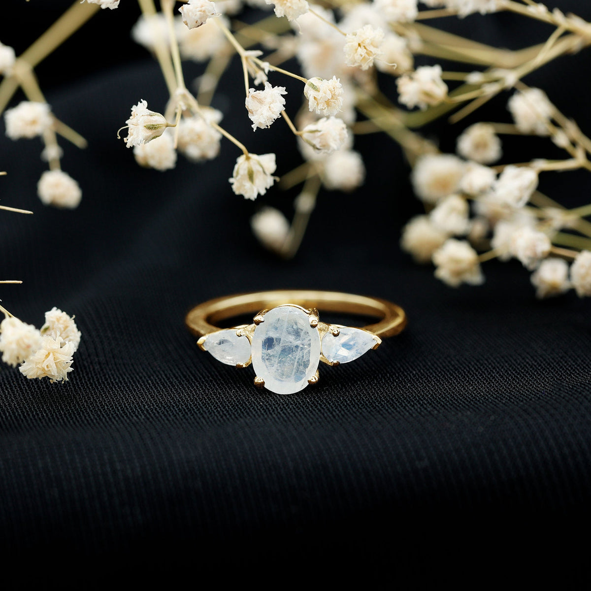 Natural moonstone three-stone engagement ring by Rosec Jewels featuring elegant, polished gemstones set in a delicate ring band
