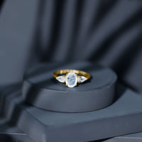 Natural moonstone three-stone engagement ring featuring rose gold band and sparkling gemstones, designed by Rosec Jewels.