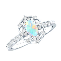 Oval Ethiopian Rainbow Opal vintage engagement ring with diamond, crafted by Rosec Jewels, showcasing intricate design and colorful stone.