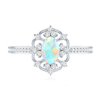 Vintage-style oval Ethiopian rainbow opal engagement ring with diamond accents from Rosec Jewels, showcasing a unique gemstone setting.