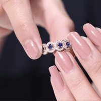 Yellow gold blue sapphire half eternity ring with diamond accents, showcasing elegant craftsmanship by Rosec Jewels.