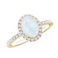 Oval moonstone engagement ring with diamond halo by Rosec Jewels, showcasing the intricate design and sparkling gemstones.