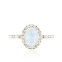 Oval moonstone engagement ring with diamond halo featuring a silver band, designed by Rosec Jewels.