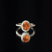 Oval 1 Carat Fire Opal engagement ring with diamond halo from Rosec Jewels, showcasing a stunning fire opal with shimmering diamonds.