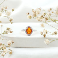 Oval 1 Carat Fire Opal engagement ring with diamond halo by Rosec Jewels, showcasing the elegant oval fire opal and sparkling diamond accents.