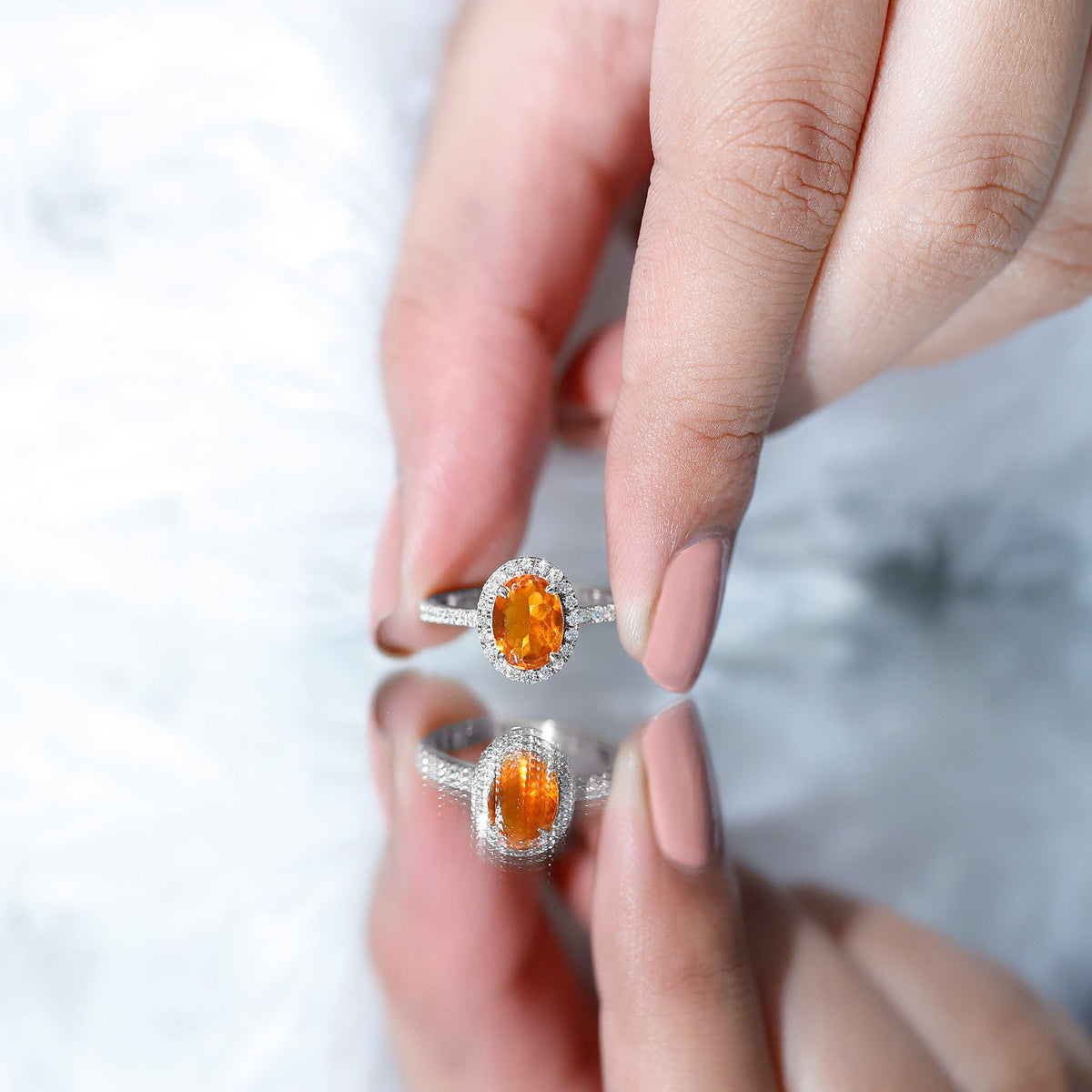 Oval 1 Carat fire opal engagement ring with diamond halo by Rosec Jewels, featuring a central fiery opal and sparkling diamond accents.