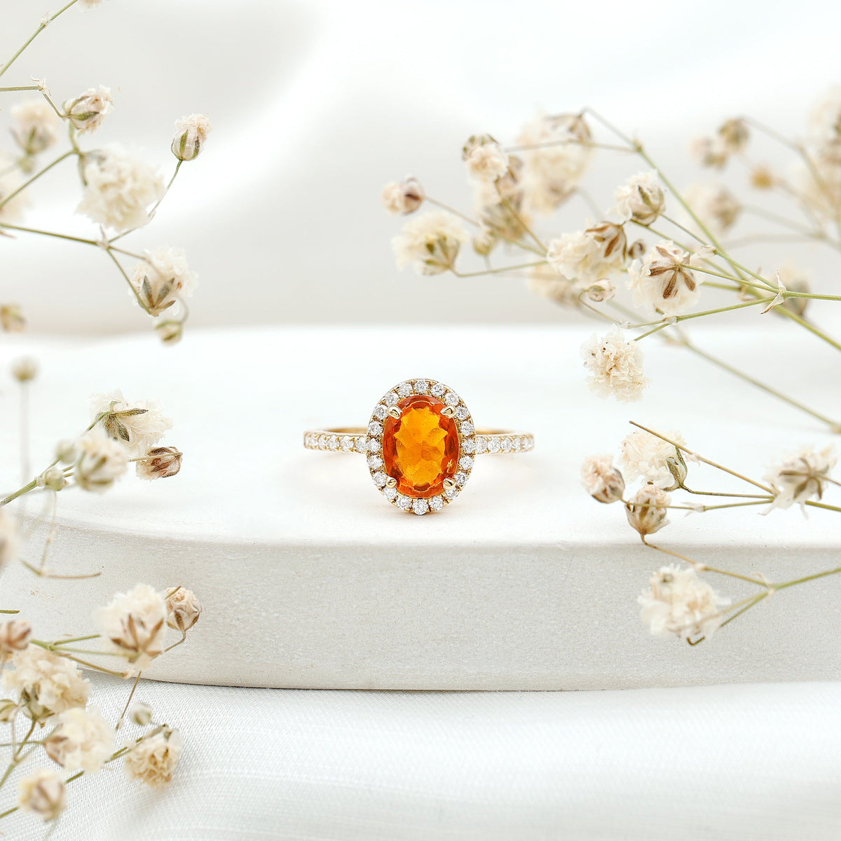 Oval 1 Carat Fire Opal engagement ring with diamond halo from Rosec Jewels, featuring a sparkling fire opal center stone and diamond accents.