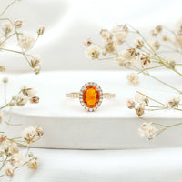 Oval 1 Carat Fire Opal engagement ring with diamond halo from Rosec Jewels, featuring a sparkling fire opal center stone and diamond accents.
