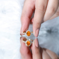 Oval 1 Carat fire opal engagement ring with diamond halo by Rosec Jewels, showcasing a sparkling gemstone and intricate band design.