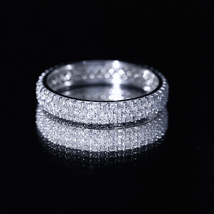 Yellow gold triple row moissanite wedding ring band for women with sparkling center stones and intricate band design.