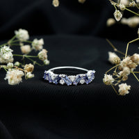Baguette cut Tanzanite and diamond half eternity stackable ring by Rosec Jewels, featuring alternating blue gemstones and sparkling diamonds