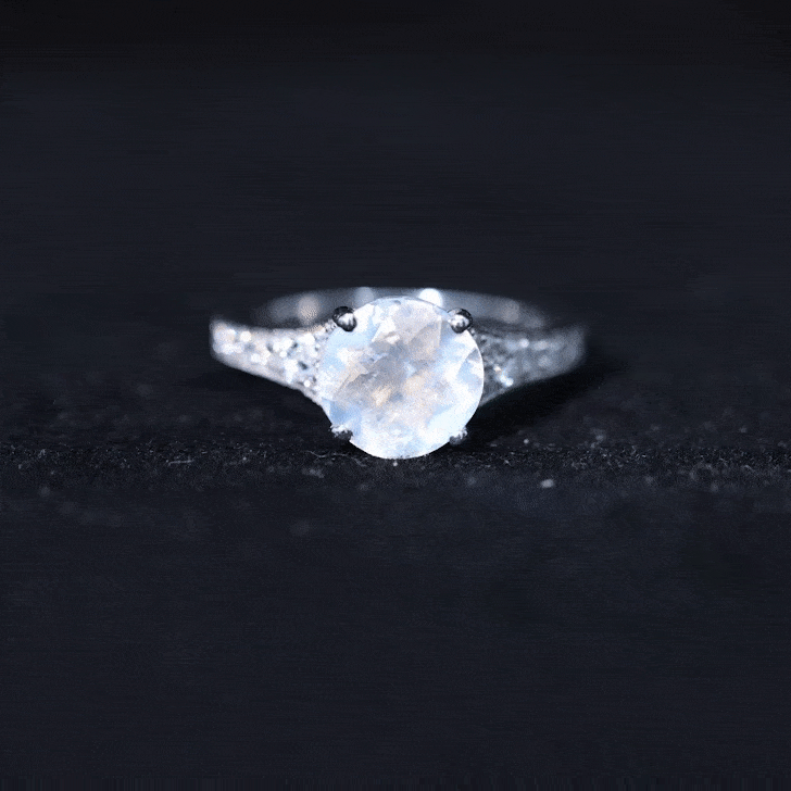 Rosec Jewels moonstone engagement ring with diamond side stones, featuring a yellow gold band and intricate design details.
