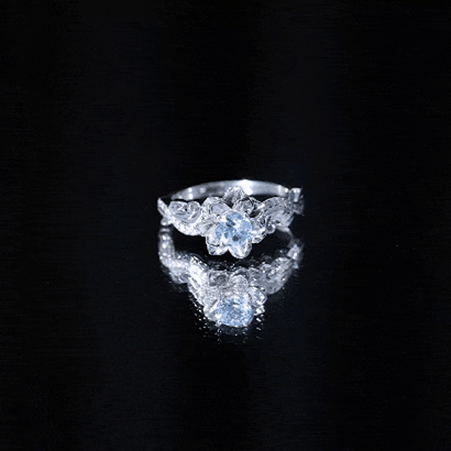 Natural aquamarine flower-inspired engagement ring with diamond accents, crafted by Rosec Jewels, featuring intricate floral design.