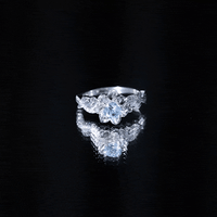 Natural aquamarine flower-inspired engagement ring with diamond accents, crafted by Rosec Jewels, featuring intricate floral design.