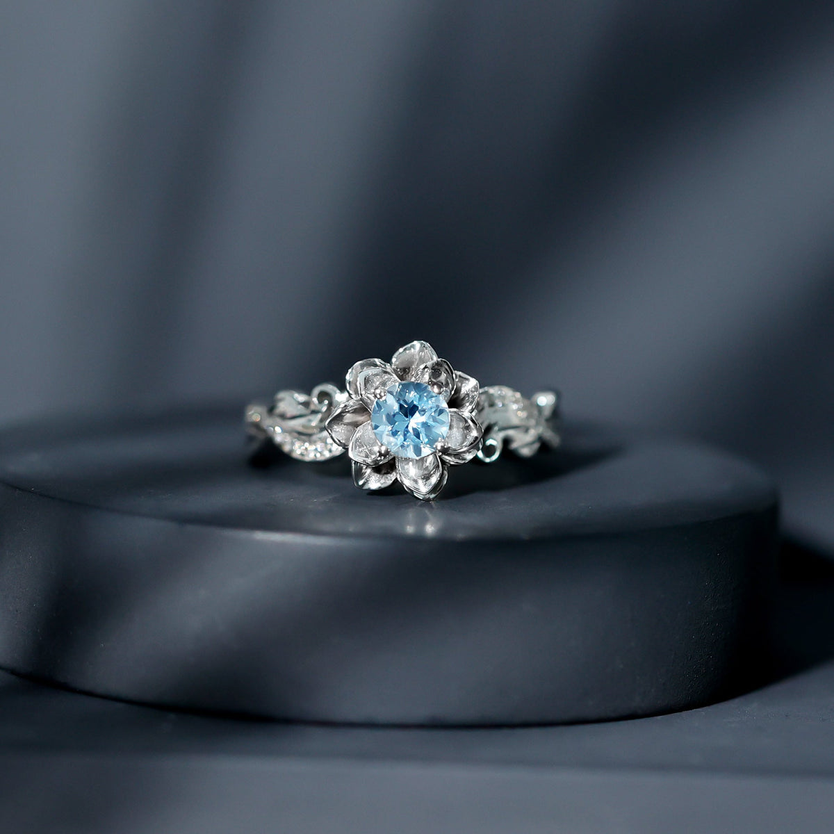 Natural aquamarine flower-inspired engagement ring with diamond accents, crafted by Rosec Jewels, showcasing intricate floral design.