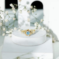 Rosec Jewels natural aquamarine engagement ring with flower-inspired design and diamond accents, showcasing intricate craftsmanship.