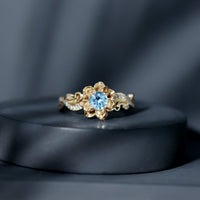 Natural aquamarine flower-inspired engagement ring with diamond accents from Rosec Jewels, showcasing intricate floral design and sparkling gemstones.