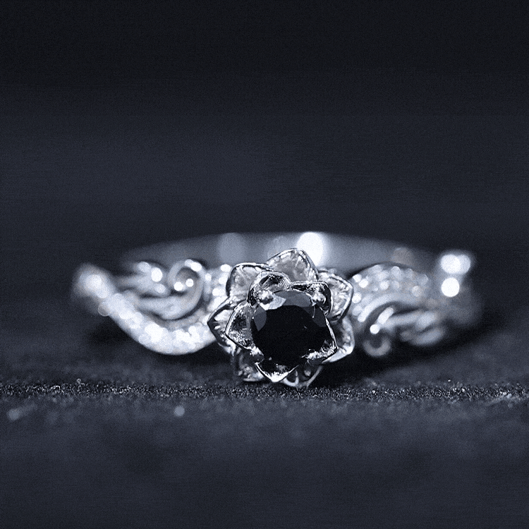 Black spinel blooming flower engagement ring with diamond accents by Rosec Jewels, showcasing intricate floral design and sparkling stones.