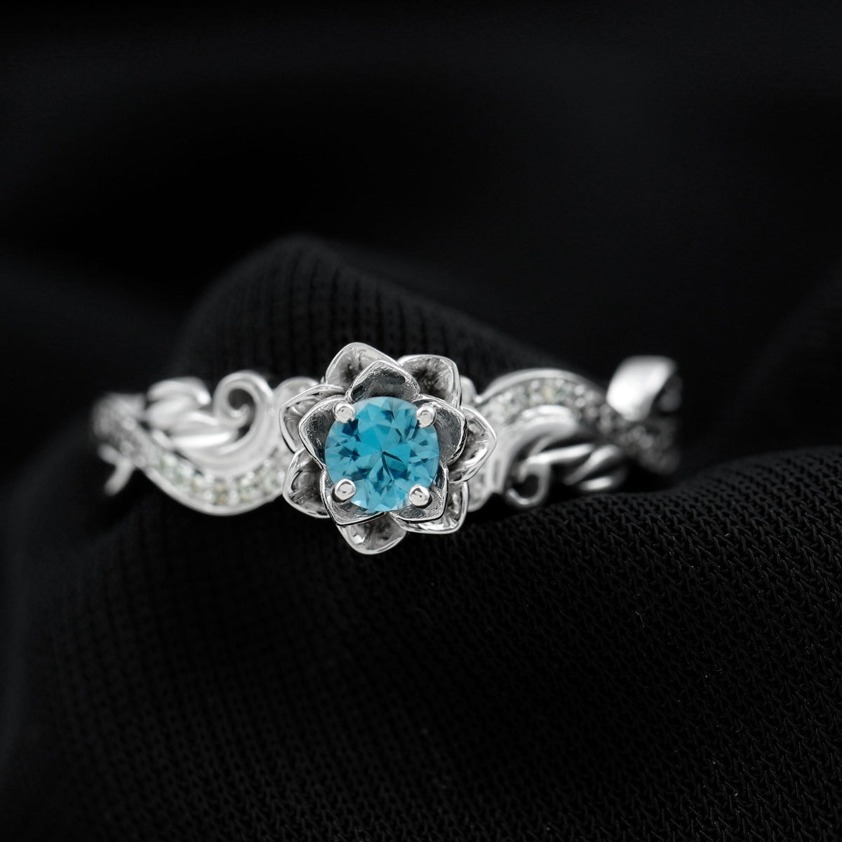 Round 0.6 carat London Blue Topaz engagement ring with diamond accents, nature-inspired design, by Rosec Jewels.