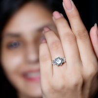 Natural moonstone rose flower engagement ring with diamond accents by Rosec Jewels, showcasing intricate floral design and sparkling gemstones.