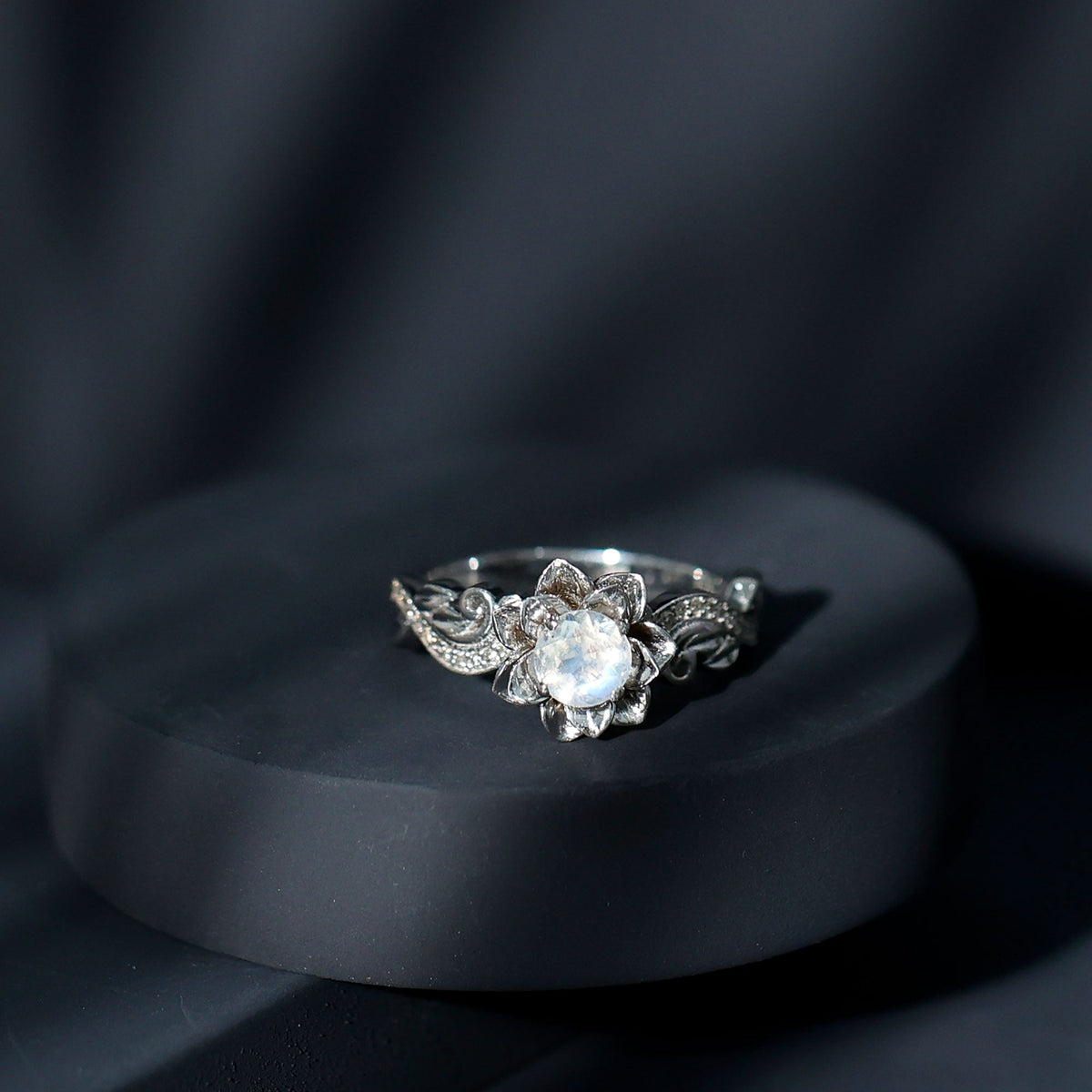 Natural moonstone rose flower engagement ring with diamond accents from Rosec Jewels, featuring intricate floral design and sparkling gemstones.