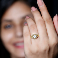 Natural moonstone rose flower engagement ring with diamond accents by Rosec Jewels, showcasing intricate floral design and sparkling gemstones.