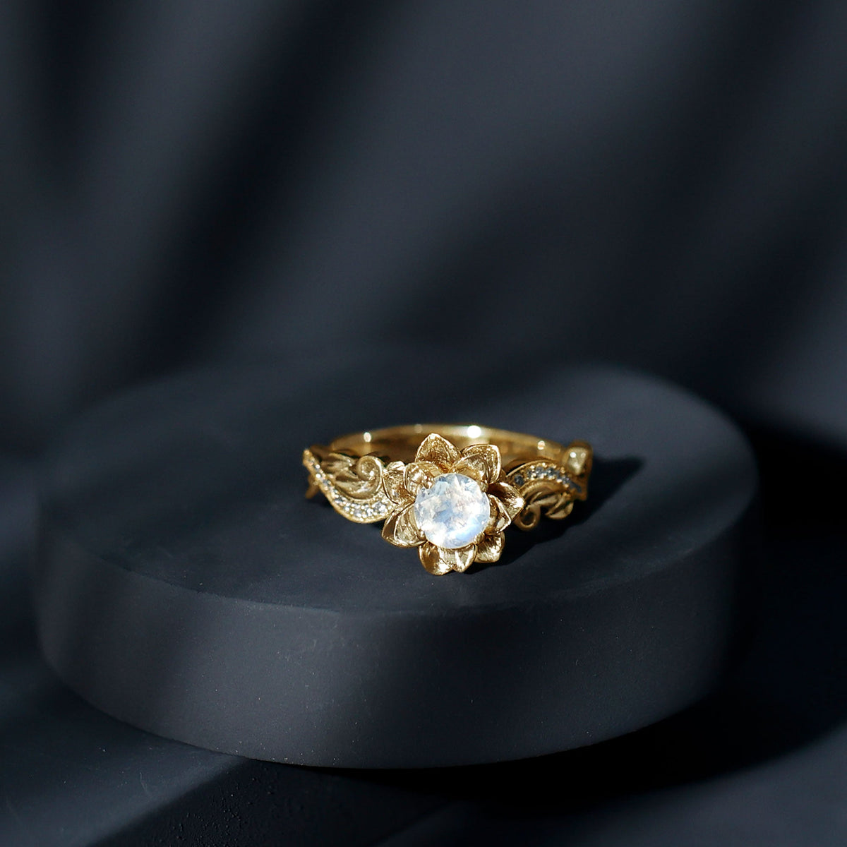 Natural moonstone rose flower engagement ring with diamond detailing, crafted by Rosec Jewels, showcasing intricate floral design.