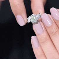 Peridot and diamond flower-inspired engagement ring from Rosec Jewels showing intricate floral design and sparkling gemstones.