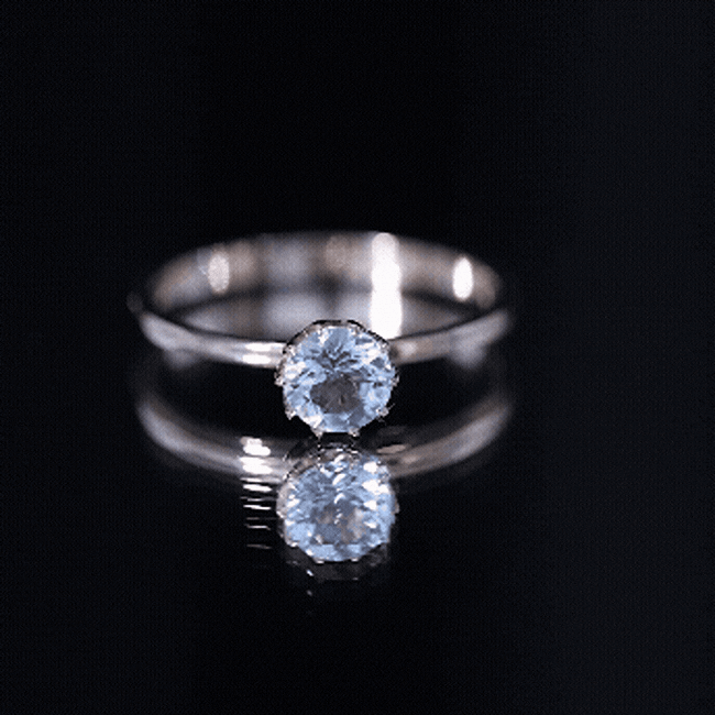 Yellow gold solitaire engagement ring featuring a 0.8 carat round cut aquamarine gemstone set in a Rosec Jewels ring.