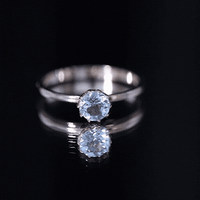 Yellow gold solitaire engagement ring featuring a 0.8 carat round cut aquamarine gemstone set in a Rosec Jewels ring.