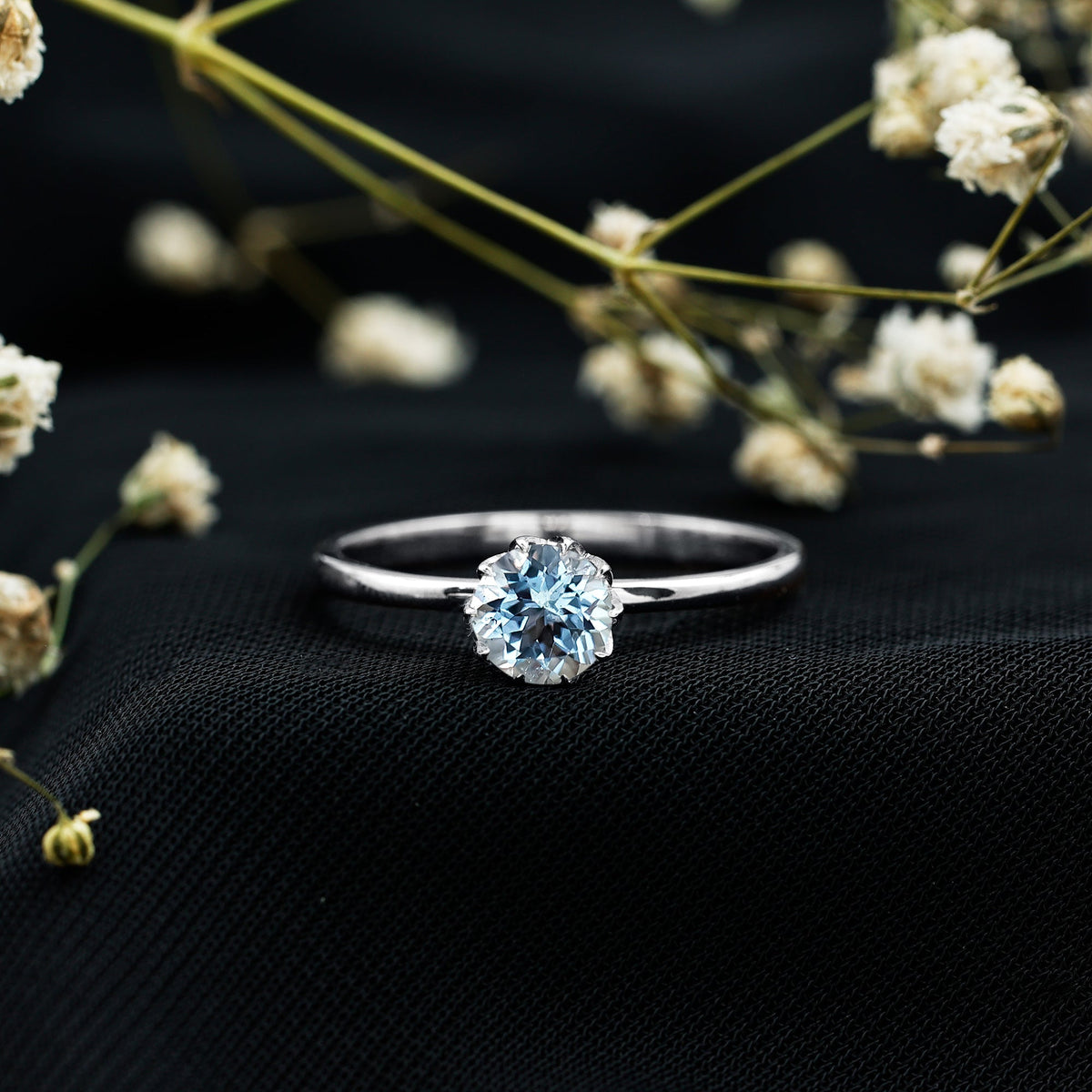 Round cut aquamarine solitaire engagement ring with 0.8 carat weight, set in a sleek ring band by Rosec Jewels.