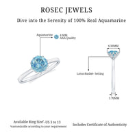Round cut aquamarine solitaire engagement ring with a 0.8 carat center stone, showcased in a sleek ring setting.