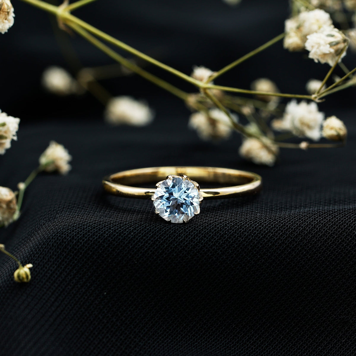 Round cut aquamarine solitaire engagement ring with a 0.8 carat gemstone set in a sleek band, designed by Rosec Jewels.