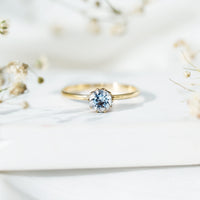 0.8 carat round cut aquamarine solitaire engagement ring by Rosec Jewels, featuring a sparkling aquamarine gemstone on a sleek band.