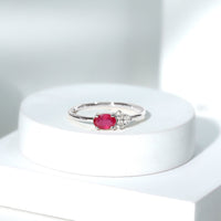 East West Style 0.6 Carat Oval Ruby Promise Ring with Diamond Trio