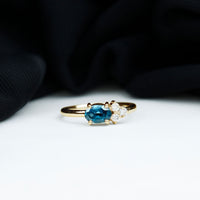 0.4 Carat Oval Cut London Blue Topaz East West Promise Ring with Diamond Trio