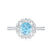 Genuine 0.8 carat aquamarine floral engagement ring with diamond side stones, featuring intricate floral design and sterling silver band.