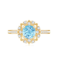 Genuine 0.8ct aquamarine floral engagement ring with diamond side stones by Rosec Jewels featuring intricate floral design.