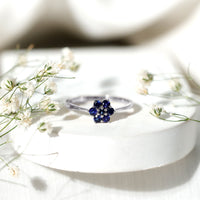 Blue sapphire cluster flower ring with round shape sapphires and silver band, crafted by Rosec Jewels.
