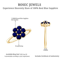 Round blue sapphire cluster flower ring by Rosec Jewels featuring a silver band and a floral design with multiple sapphires.