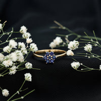 Round shape blue sapphire cluster flower ring by Rosec Jewels featuring a floral design with sparkling blue sapphires.