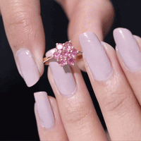 Round pink tourmaline flower engagement ring from Rosec Jewels, showcasing a delicate floral design with a pink gemstone centerpiece.