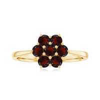 Natural garnet flower cluster engagement ring with detailed gold band, featuring vibrant red garnet stones arranged in a floral design.