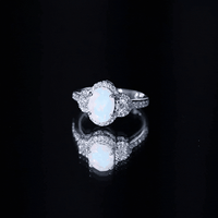 Vintage-inspired opalescent oval engagement ring with real diamond from Rosec Jewels, showcasing a yellow band and intricate design.